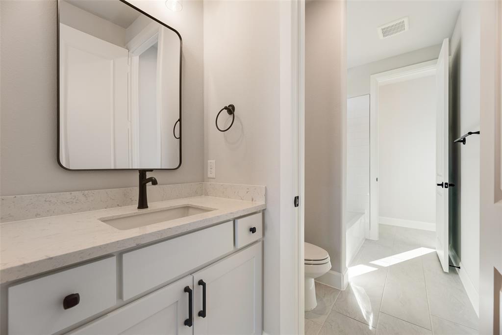 5251 Sunset Road Caddo Mills, TX 75135 - Photo 18 of 32 a bath room with a toilet and a sink