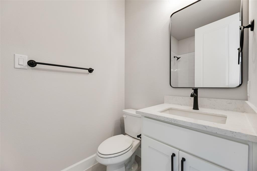 5251 Sunset Road Caddo Mills, TX 75135 - Photo 21 of 32 a bathroom with a toilet sink and mirror
