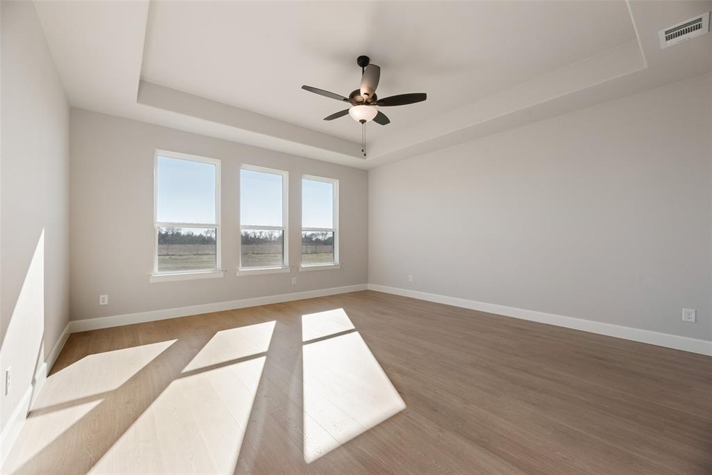 5251 Sunset Road Caddo Mills, TX 75135 - Photo 25 of 32 a view of an empty room with wooden floor and a window