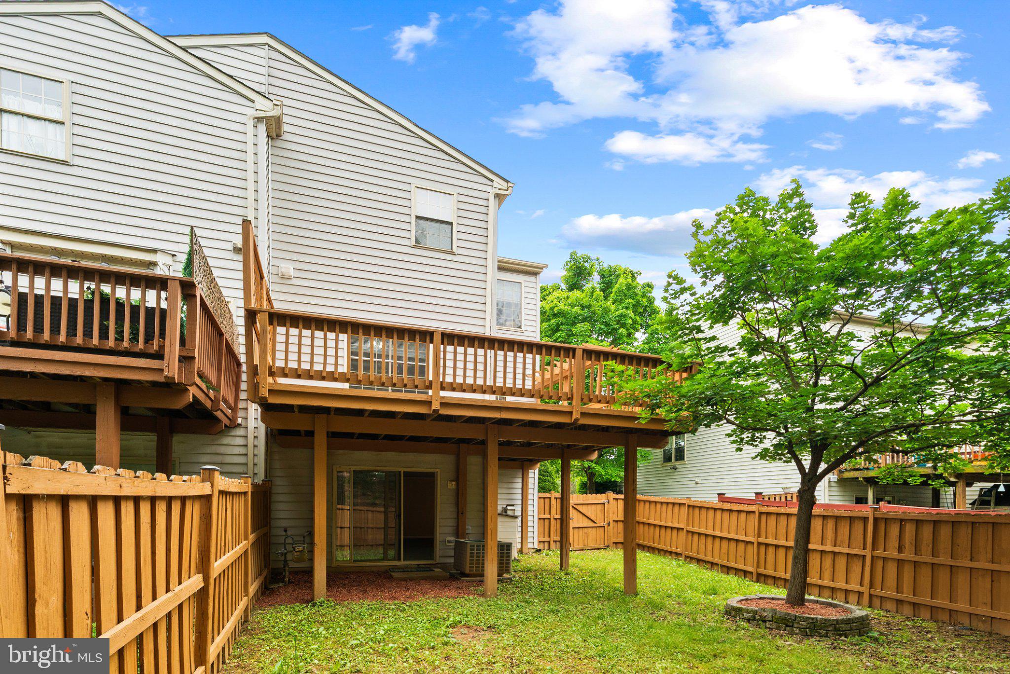 1709 Woodruff Way Frederick, MD 21701 - Photo 25 of 42 a view of a house with wooden deck and a yard