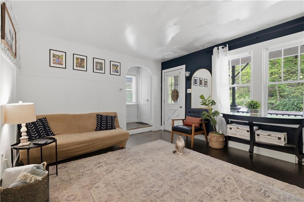 2646 Library Road Pittsburgh, PA 15234 - Photo 3 of 25 LVP flooring, a decorative fireplace, beautiful built-ins, and stained glass windows add warmth and timeless character throughout the home. Cute cat is not included