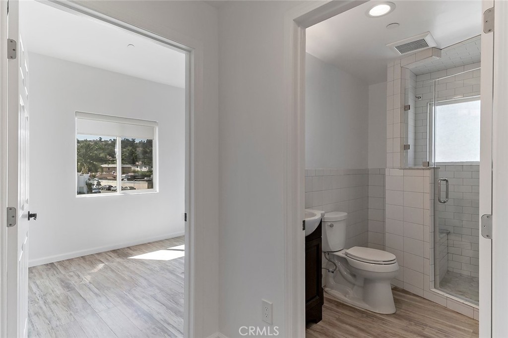 4620 Eagle Rock Boulevard, Unit 1/2 Eagle Rock, CA 90041 - Photo 13 of 26 a bathroom with a granite countertop toilet a sink and a mirror