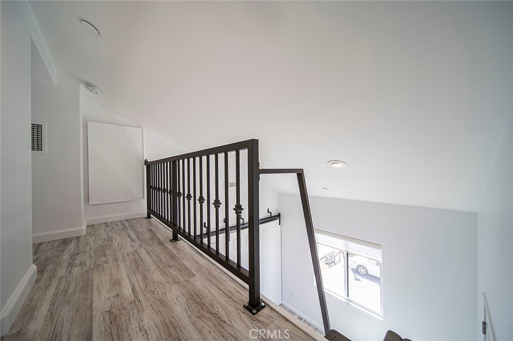 4620 Eagle Rock Boulevard, Unit 1/2 Eagle Rock, CA 90041 - Photo 22 of 26 a view of a hallway with wooden floor and stairs