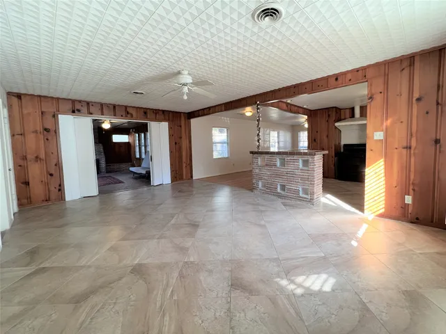 a view of a hallway with wooden shelves