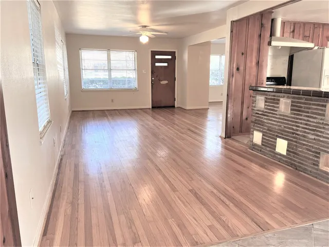 wooden floor in an empty room with a window