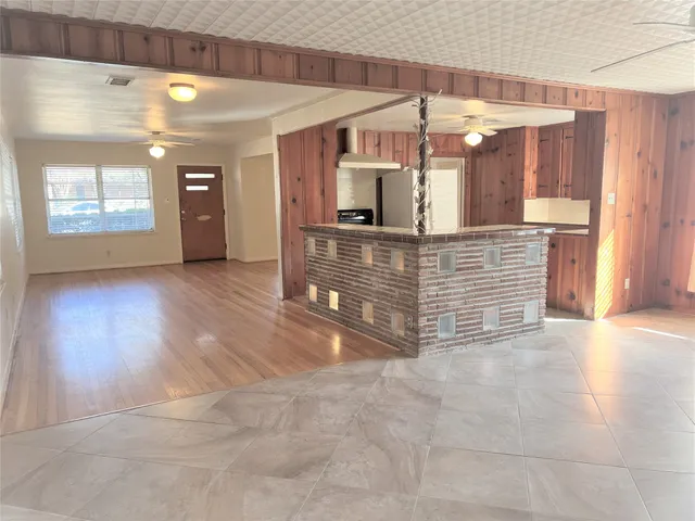 a view of living room with kitchen island granite countertop furniture and a fireplace