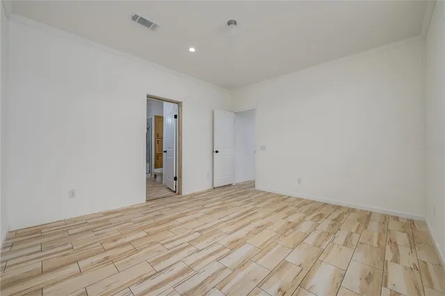 a view of an empty room and wooden floor