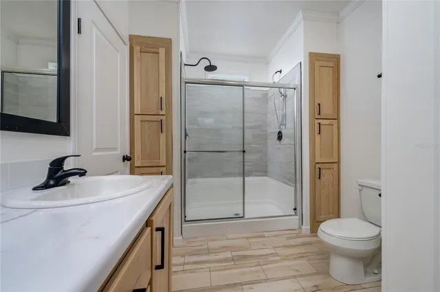 a bathroom with a sink toilet and shower