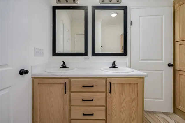 a bathroom with a sink vanity and mirror