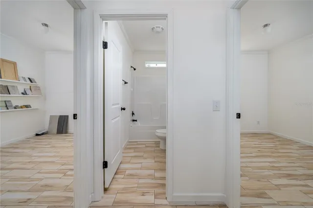 a view of a bedroom with wooden floor and staircase
