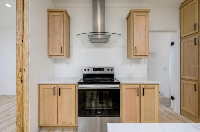 a kitchen with stainless steel appliances granite countertop a stove and a refrigerator