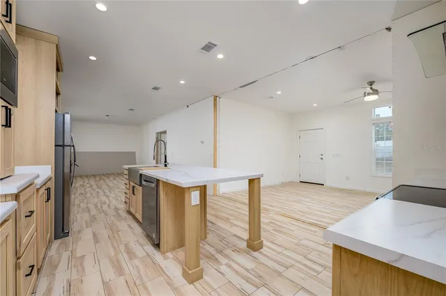 a view of a kitchen with sink and wooden floor