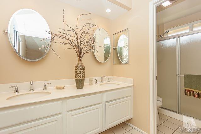 4347 Laurelhurst Road Moorpark, CA 93021 - Photo 16 of 23 a bathroom with a sink mirror and vanity