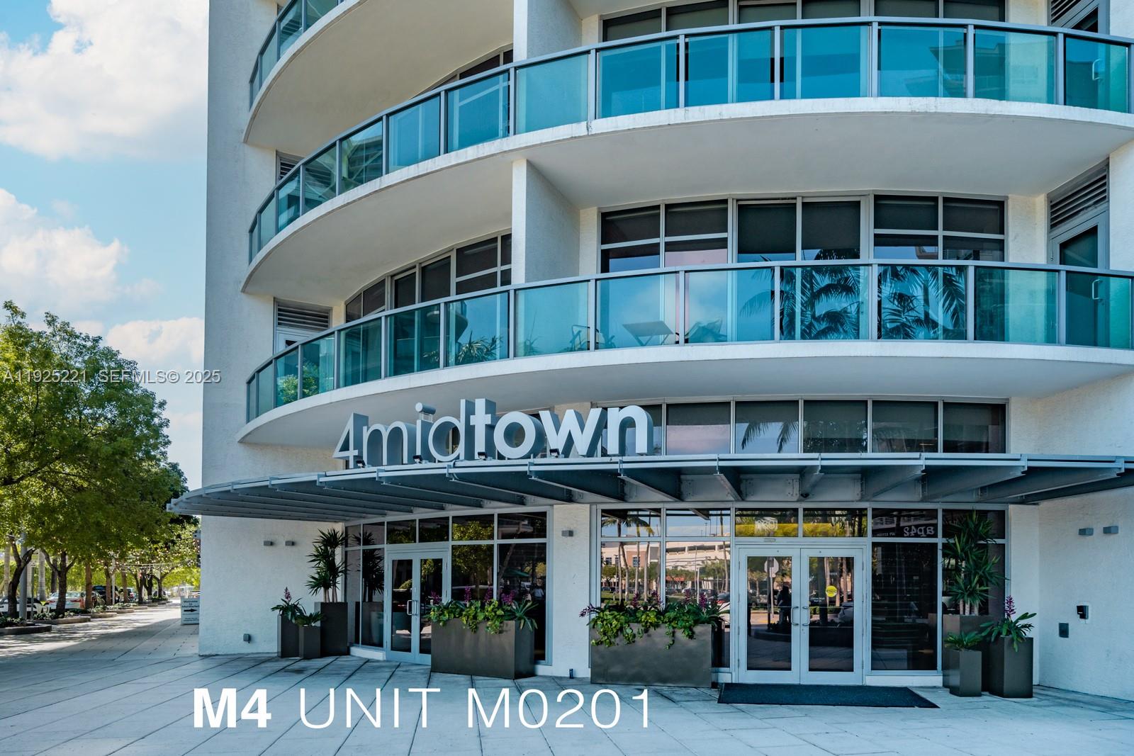 3301 Northeast 1st Avenue, Unit M0201 Miami, FL 33137 - Photo 20 of 20 a view of tall building with large window and plants