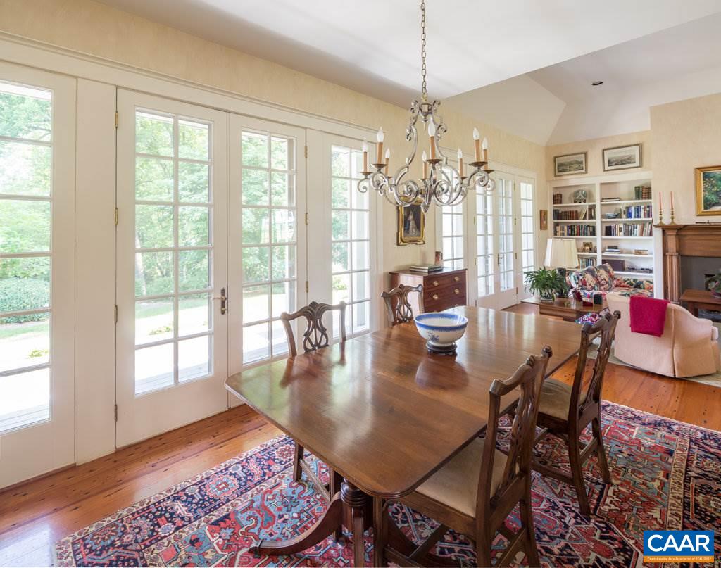 4054 Garth Road Crozet, VA 22932 - Photo 17 of 50 a view of a dining room and livingroom with furniture wooden floor a rug a chandelier and a rug