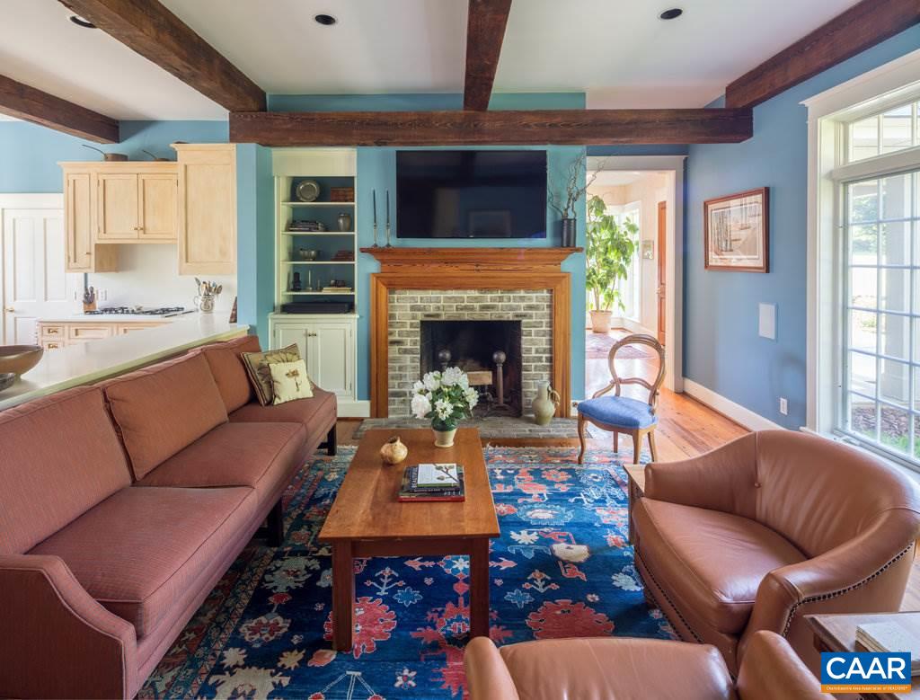 4054 Garth Road Crozet, VA 22932 - Photo 21 of 50 a living room with furniture fireplace and a flat screen tv