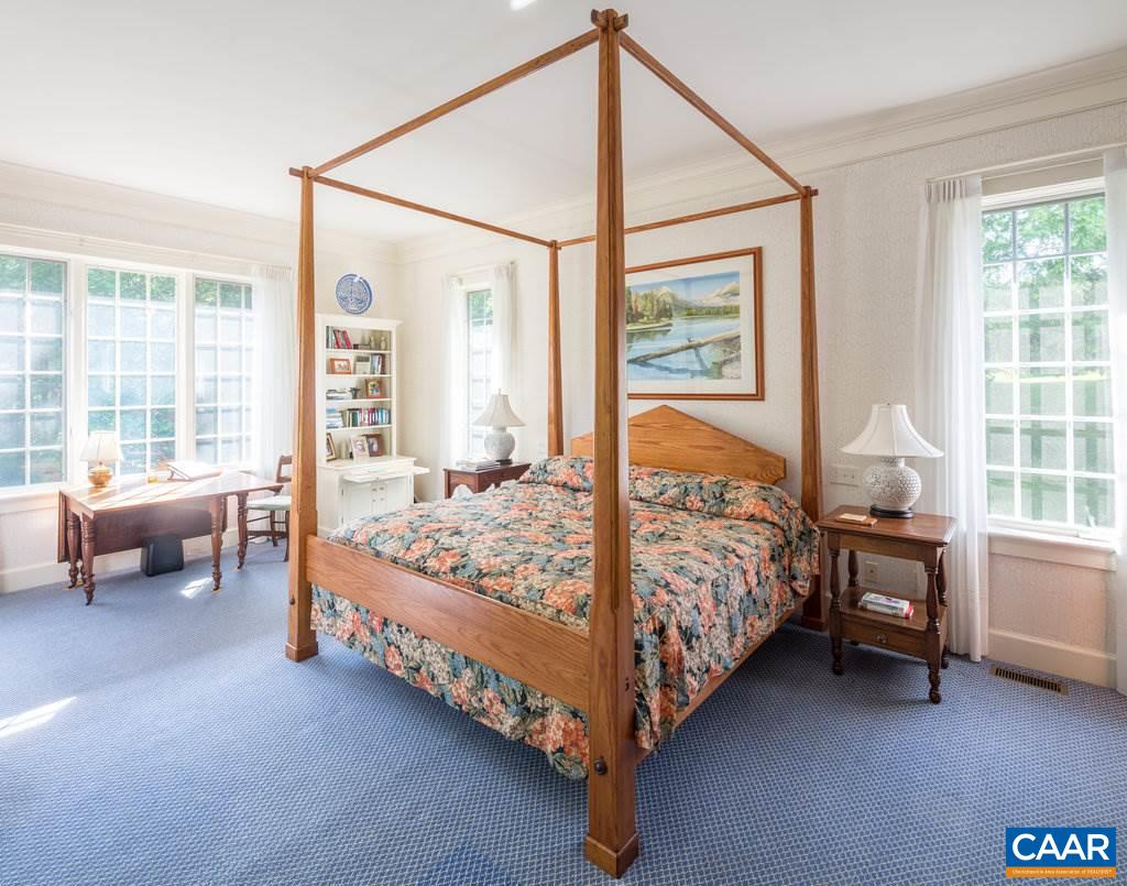 4054 Garth Road Crozet, VA 22932 - Photo 26 of 50 a bed sitting in a bedroom next to a window