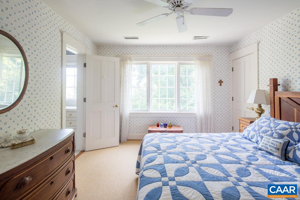 4054 Garth Road Crozet, VA 22932 - Photo 30 of 50 a bedroom with a bed and a chandelier