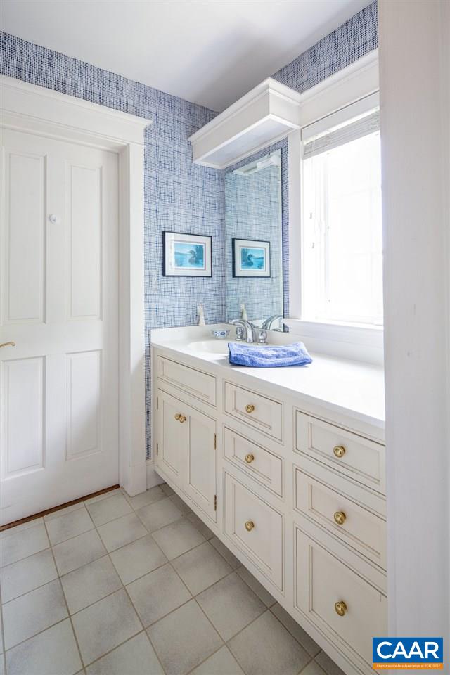 4054 Garth Road Crozet, VA 22932 - Photo 31 of 50 a bathroom with a sink a mirror and a vanity