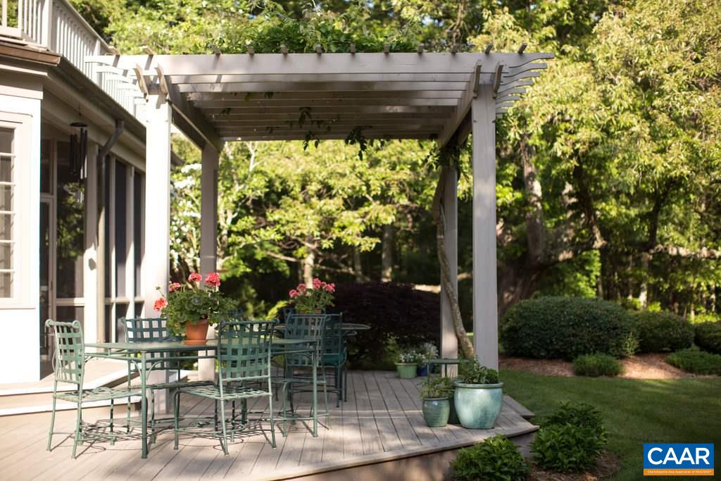 4054 Garth Road Crozet, VA 22932 - Photo 35 of 50 a backyard of a house with fountain table and chairs