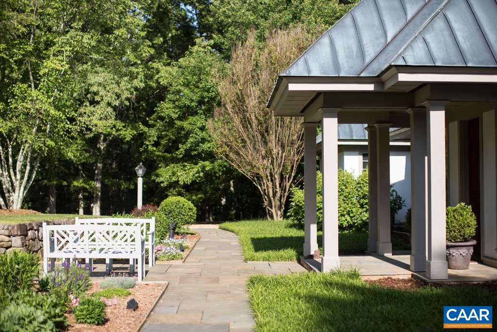 4054 Garth Road Crozet, VA 22932 - Photo 9 of 50 a view of brick house with a yard and plants