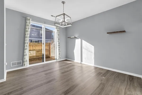 a kitchen with stainless steel appliances kitchen island granite countertop a refrigerator and a stove top oven