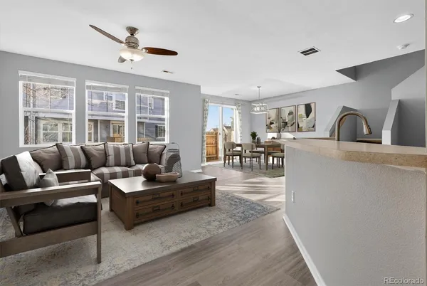 a view of a livingroom with a kitchen and wooden floor