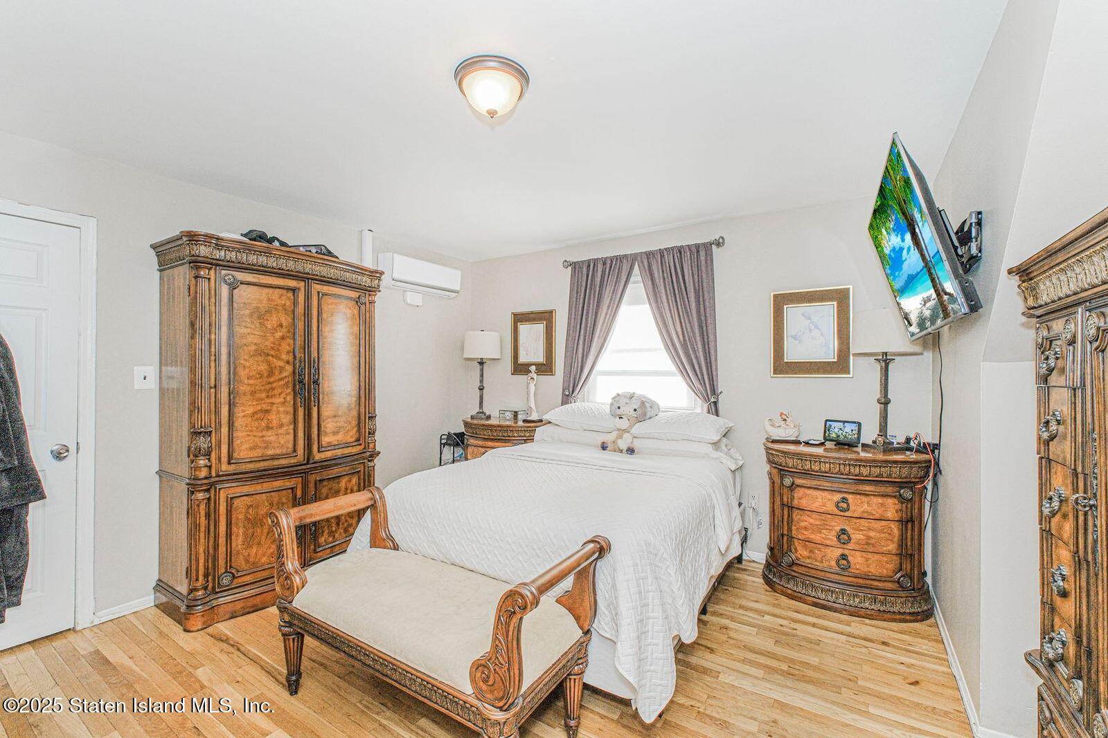 45 Lenevar Avenue Staten Island, NY 10309 - Photo 13 of 35 a bedroom with a bed and wooden floor