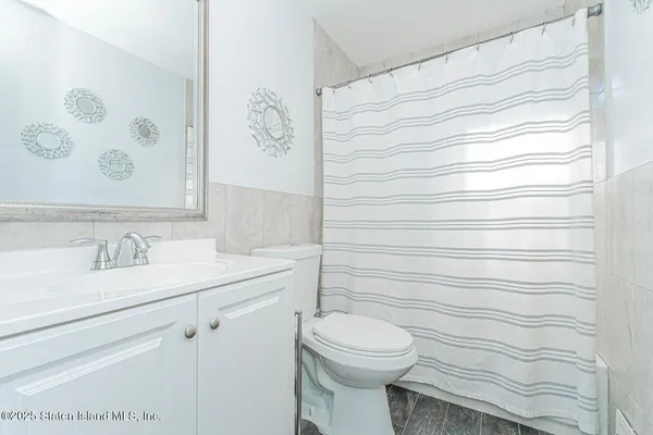 a bathroom with a toilet sink and vanity