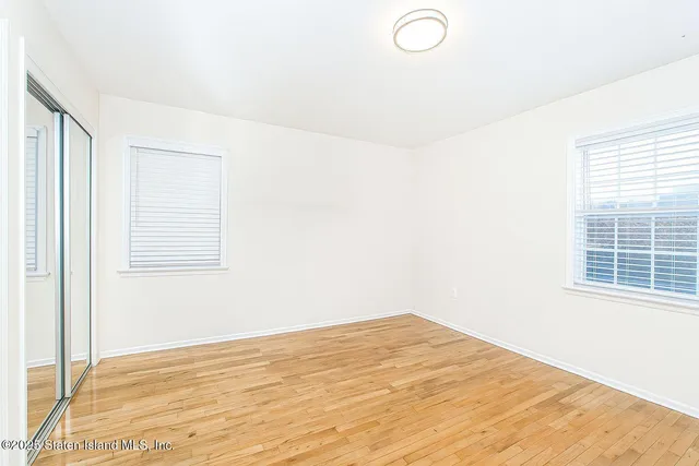 a view of a room with wooden floor and fan