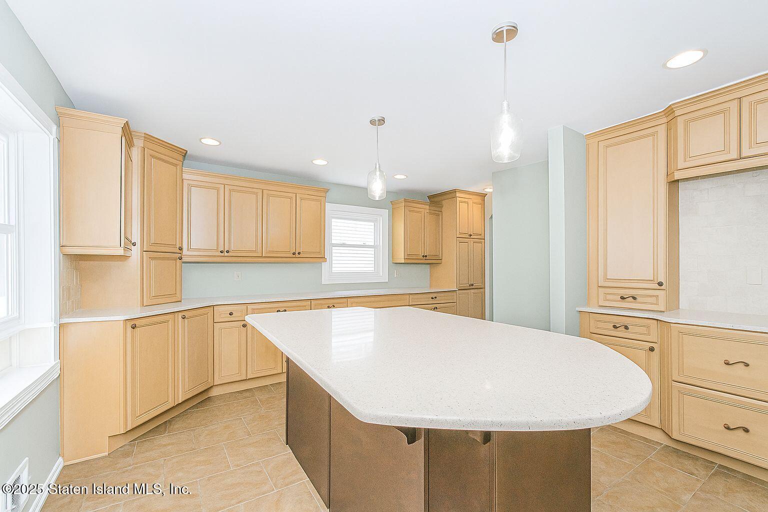 45 Lenevar Avenue Staten Island, NY 10309 - Photo 25 of 35 a room with stainless steel appliances kitchen island granite countertop a sink a refrigerator and white cabinets with wooden floor