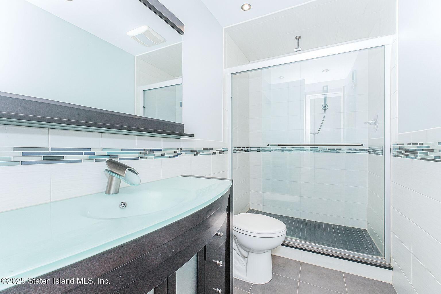 45 Lenevar Avenue Staten Island, NY 10309 - Photo 30 of 35 a bathroom with a sink a toilet and shower