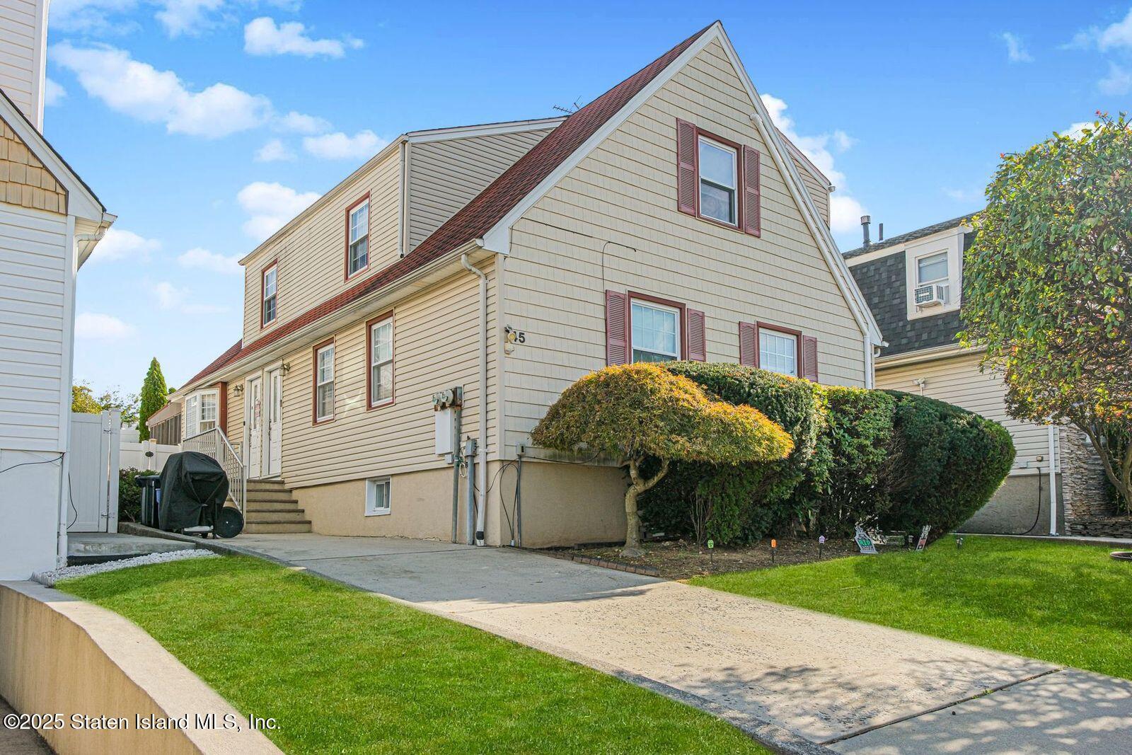 45 Lenevar Avenue Staten Island, NY 10309 - Photo 3 of 35 a front view of a house with a yard and trees