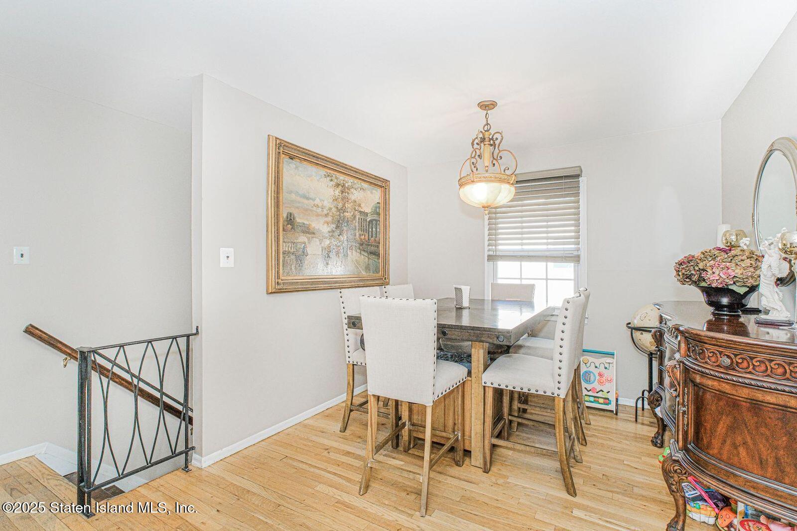 45 Lenevar Avenue Staten Island, NY 10309 - Photo 9 of 35 a dining room with furniture a chandelier and wooden floor