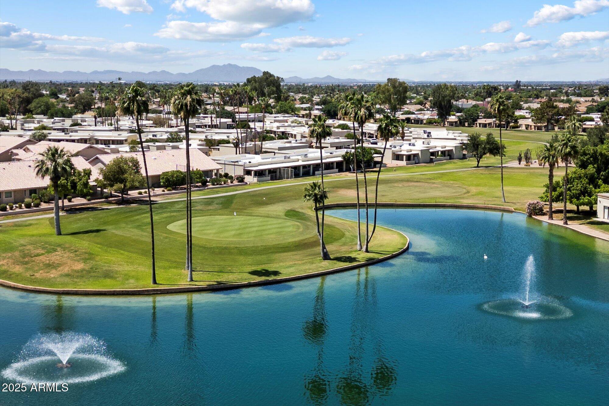a view of a swimming pool with a yard