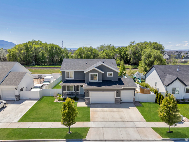 646 South Meade Street Mapleton, UT 84664 - Photo 2 of 46 Two-story residence featuring a gray exterior with stone accents, a two-car garage, and a manicured front lawn