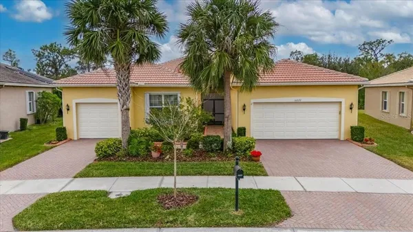 a house that has a palm tree in front of it