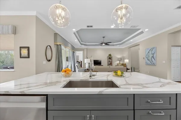 a kitchen with a dining table chairs and white cabinets