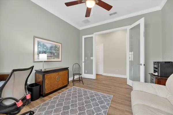 a living room with furniture and a floor to ceiling window
