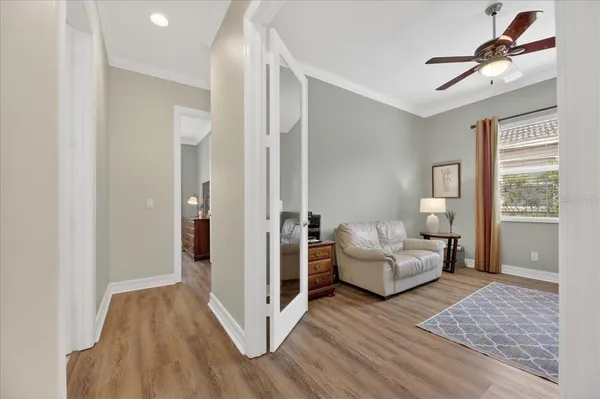 a living room with furniture a flat screen tv and a large window