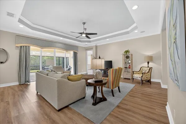 a living room with furniture and a wooden floor