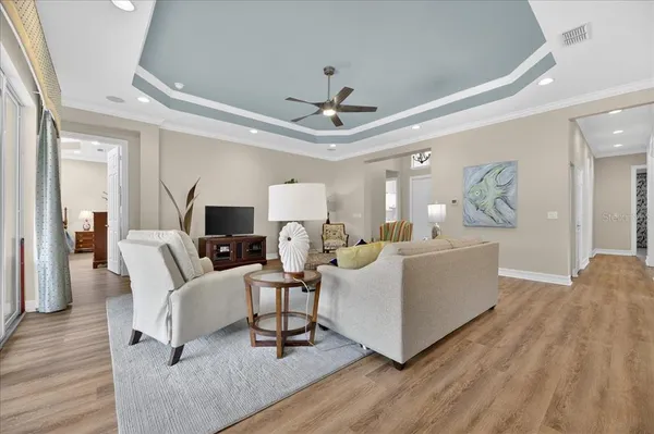 a living room with furniture and a chandelier