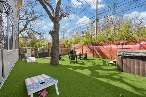 a view of a backyard with table chair and a fire pit