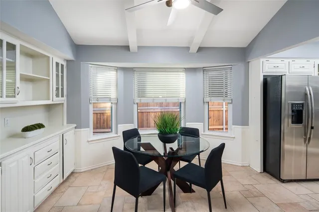 a dining room with furniture and window