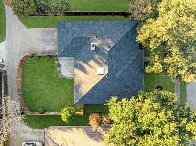 an aerial view of a house with a yard