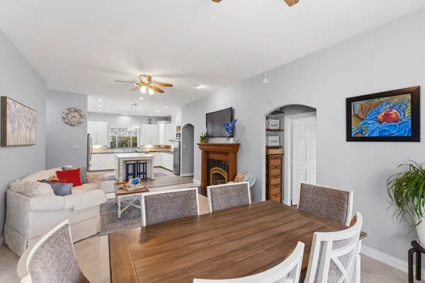 a view of a dining room with furniture a chandelier and wooden floor