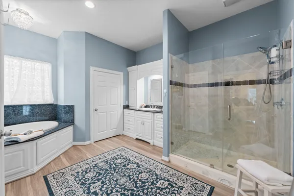 a spacious bathroom with a shower and a sink