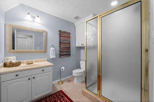 a bedroom with a bed and painting on the wall