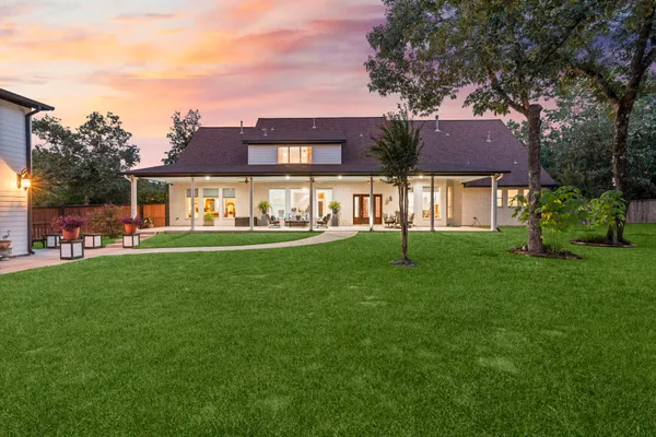 a backyard of a house with table and chairs