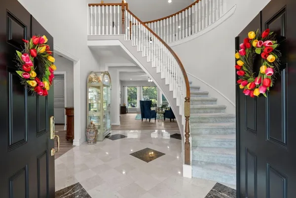 a kitchen with a refrigerator a sink dishwasher a stove and white cabinets with wooden floor